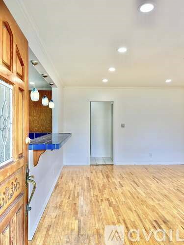 A room with wooden floors and a glass door.