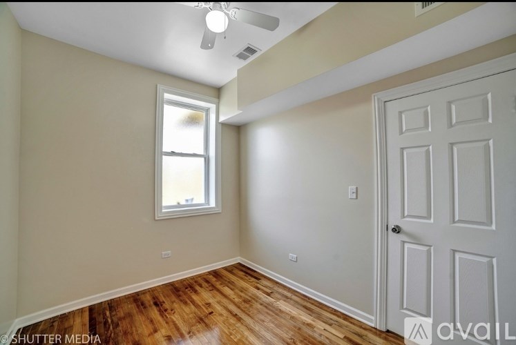 A room with a white door and a window with a white frame.