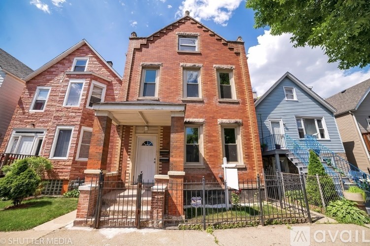 A red brick house with a white door and windows.