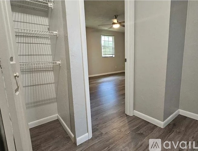 A white closet with a window in the background.