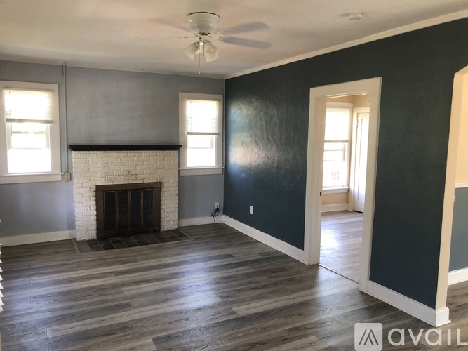 A room with a fireplace and a ceiling fan.
