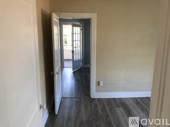 A hallway with a door on the left and a door on the right.