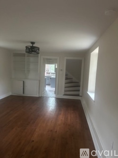 A room with wooden floors and a chandelier.