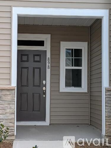 A grey door with a white frame and a window with a white frame.