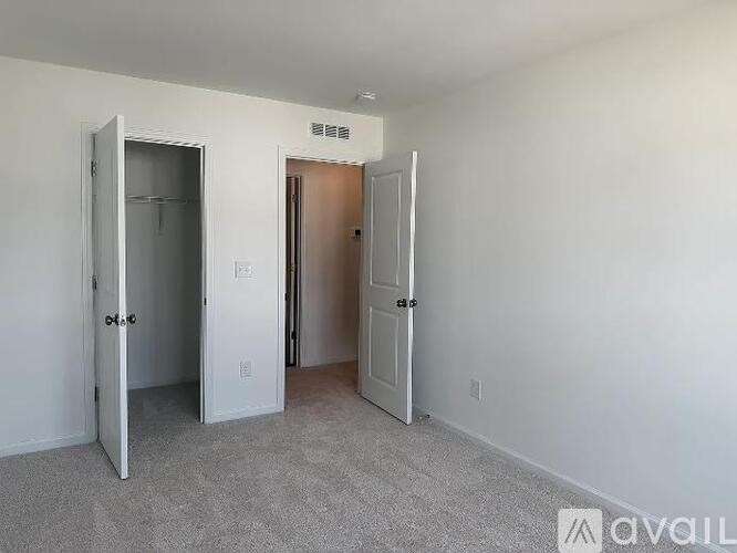 A room with two doors, one of which is open.