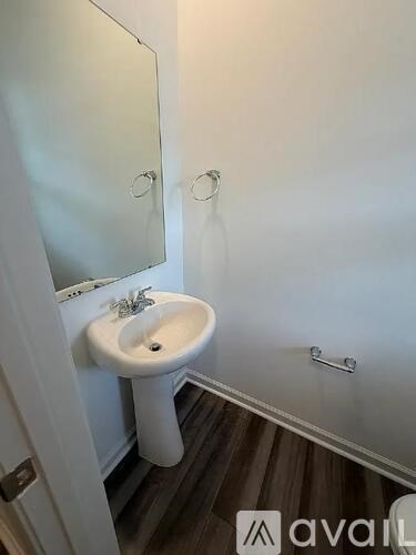 A white sink in a small bathroom.