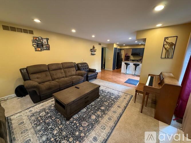A living room with a brown sofa and a coffee table.