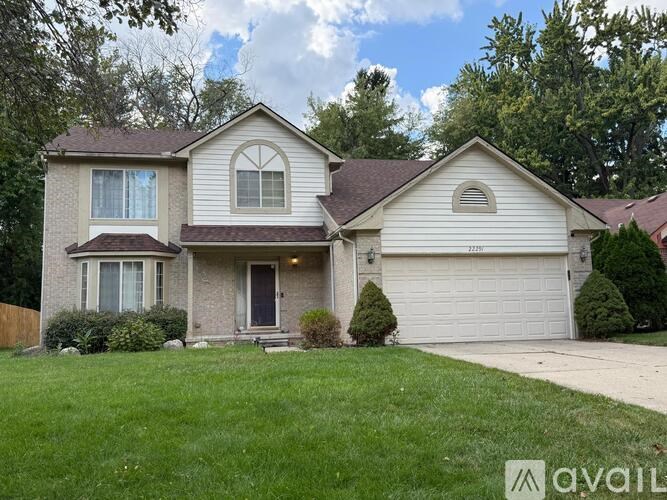 A two-story house with a garage and a front yard.