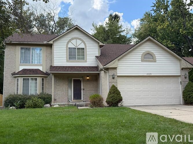 A two-story house with a garage is for sale.
