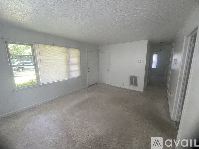 A room with a car parked outside the window.