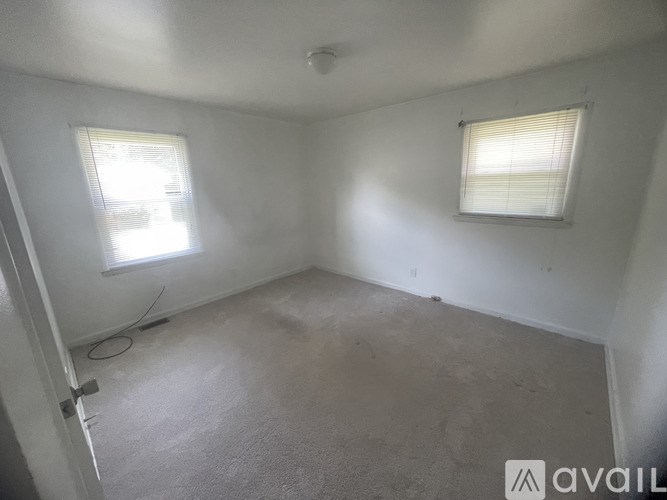 A room with a window and a door.