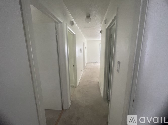 A long hallway with doors on both sides.