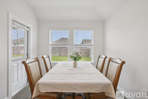 A dining room with a table set for six.