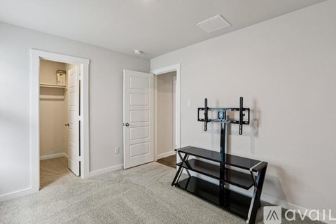 A black and white photo of a room with a bench and a door.