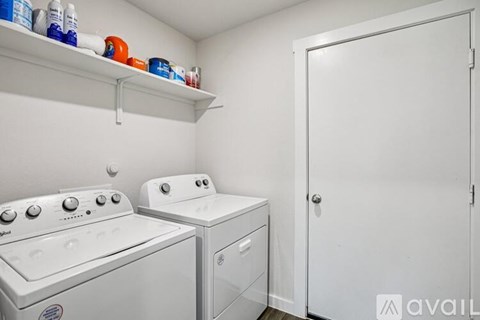 A white laundry room with a washer and dryer.