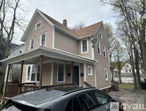 A house with a car parked in front of it.