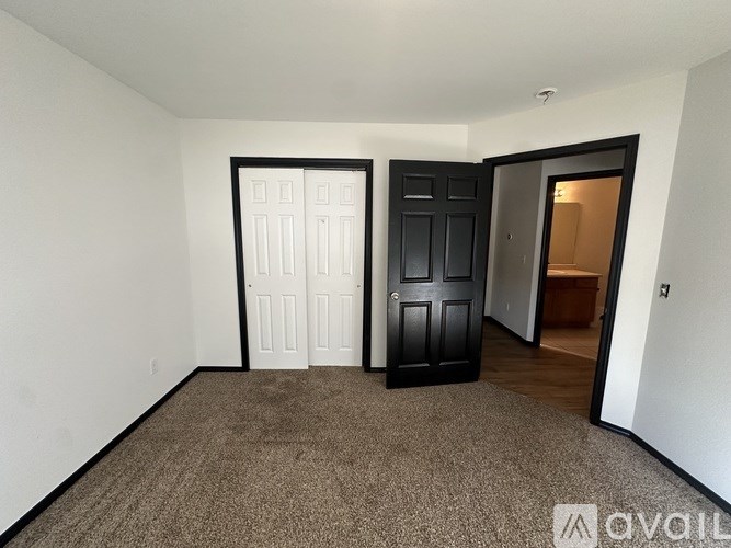 A room with two doors, one black and one white.