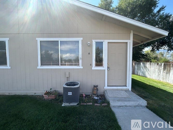A house with a white door and windows is for sale.