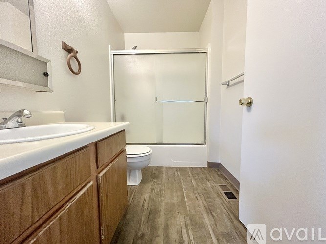 A bathroom with a toilet, sink, and shower.