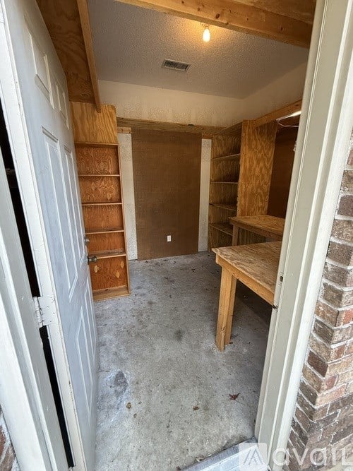 A room with a white door and a wooden bench.