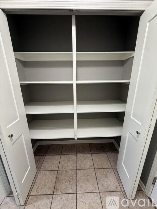 A white pantry door is open.