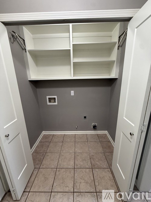 A small pantry with a white door and a white cabinet.