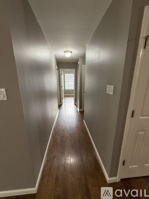 A long hallway with a light at the end.