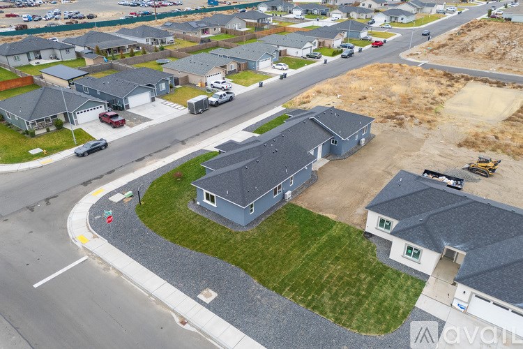 A bird's eye view of a residential area with houses and a road.