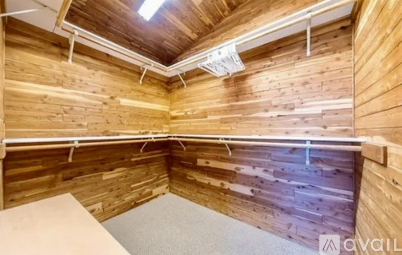 A room with wooden walls and ceiling, and a white table.