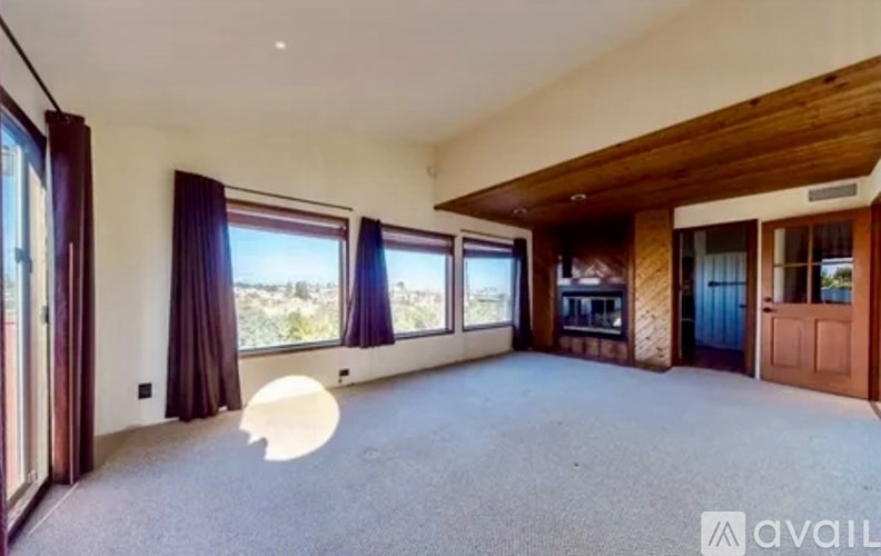 A spacious room with a large window and a view of the outdoors.