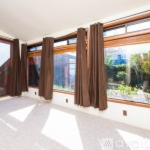 A room with brown curtains and a white floor.