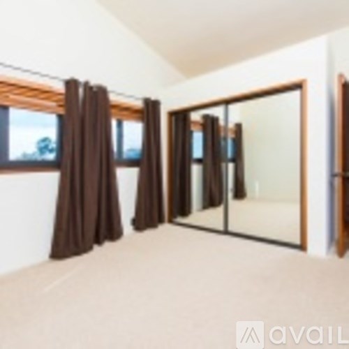 Brown curtains hang in front of a sliding glass door.