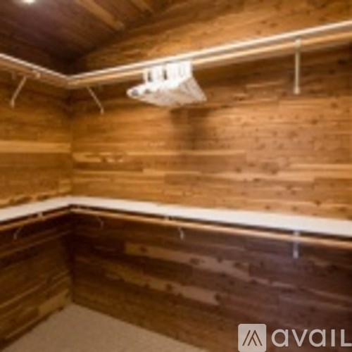 A wooden room with a white beam on the ceiling.