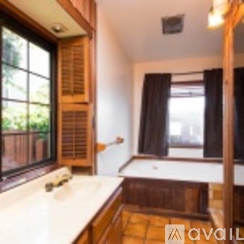 A bathroom with a window and a sink.