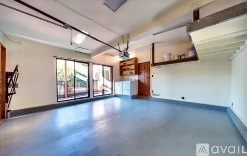 A spacious room with a washer and dryer in the corner.