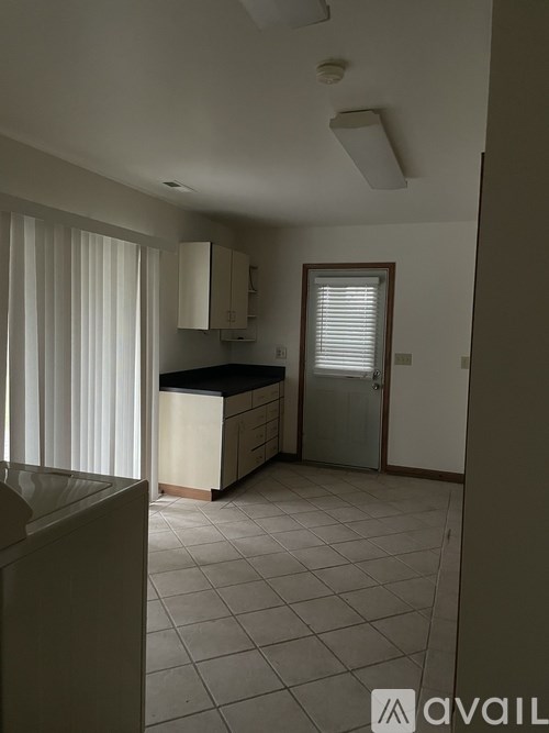A kitchen with white cabinets and a white sink.