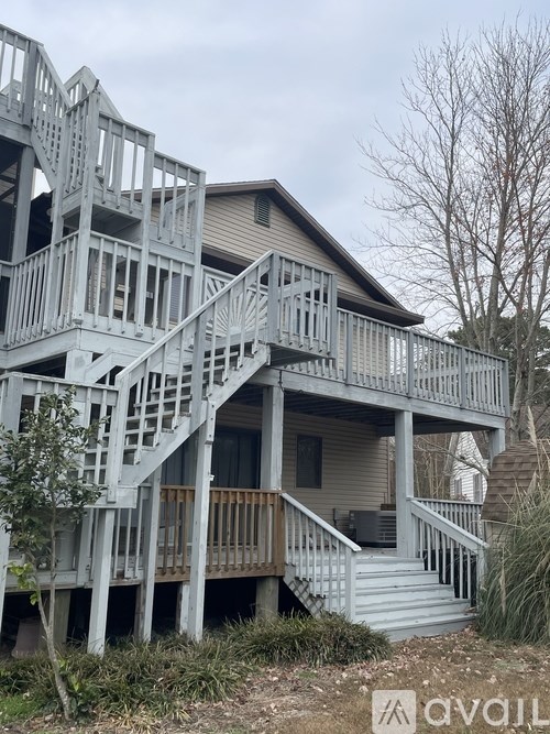 A wooden deck with stairs and railings.