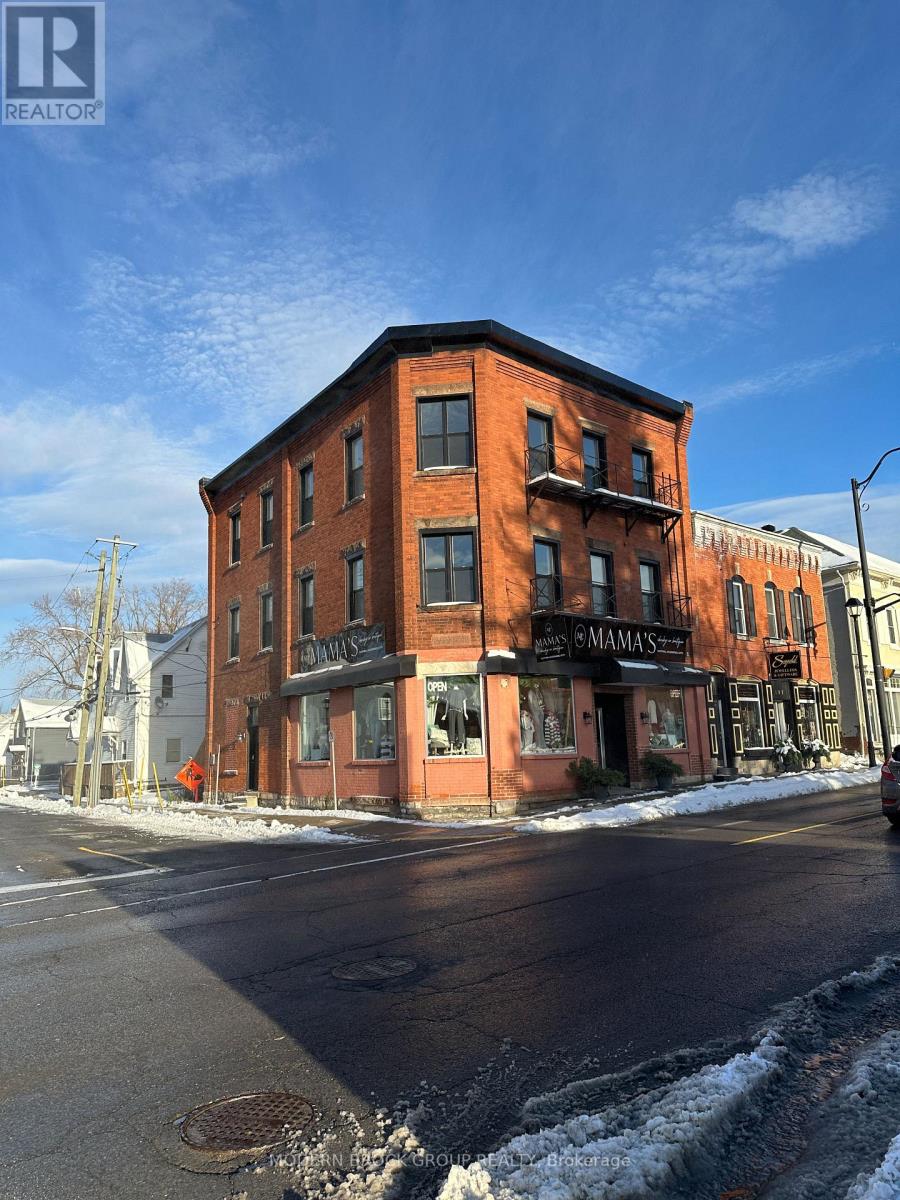 A red brick building with a black awning that says "MAMAMA" on it.