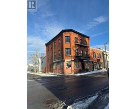 A red brick building with a black awning that says "MAMAMA" on it.