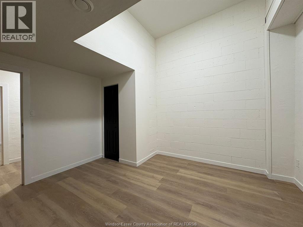 A room with a wooden floor and white walls.