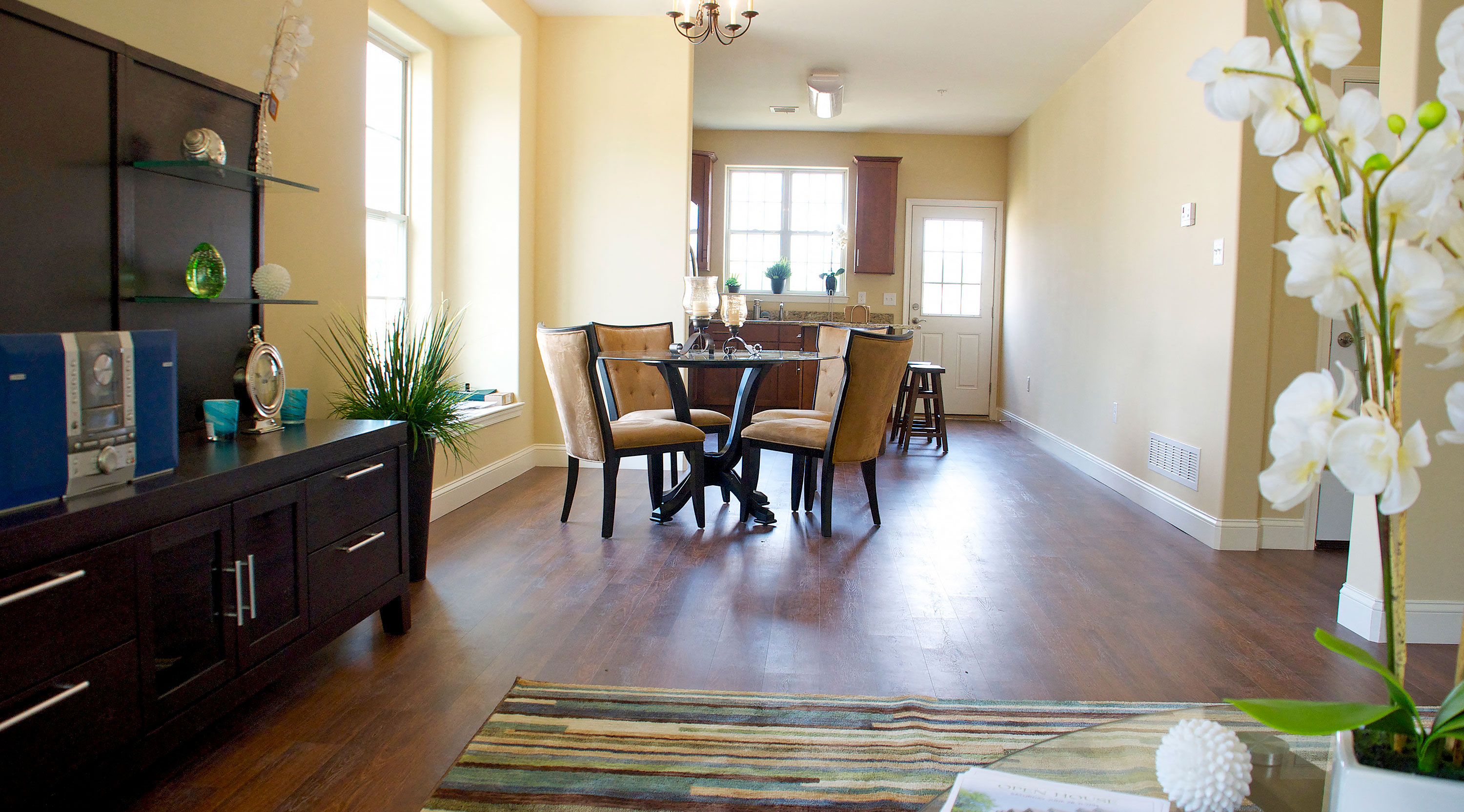 a dining room and living room with a table and chairs