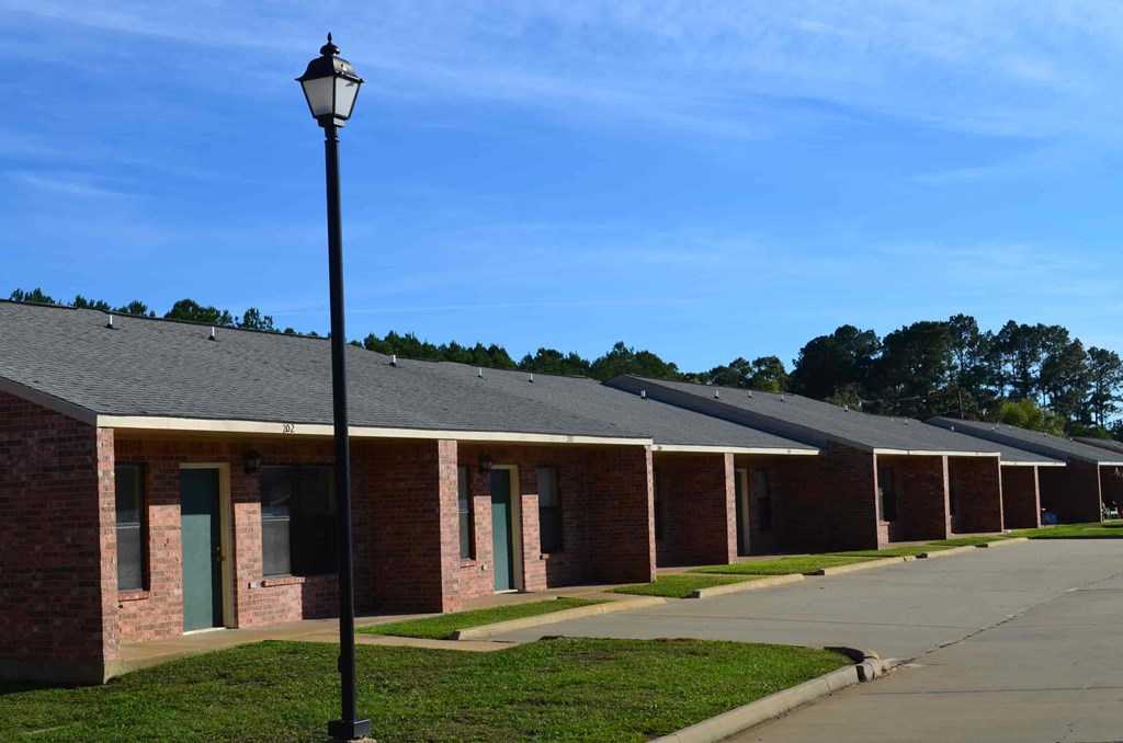 A long row of identical buildings with a lamp post in the foreground.