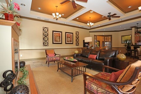 A living room with a brown carpet and furniture.