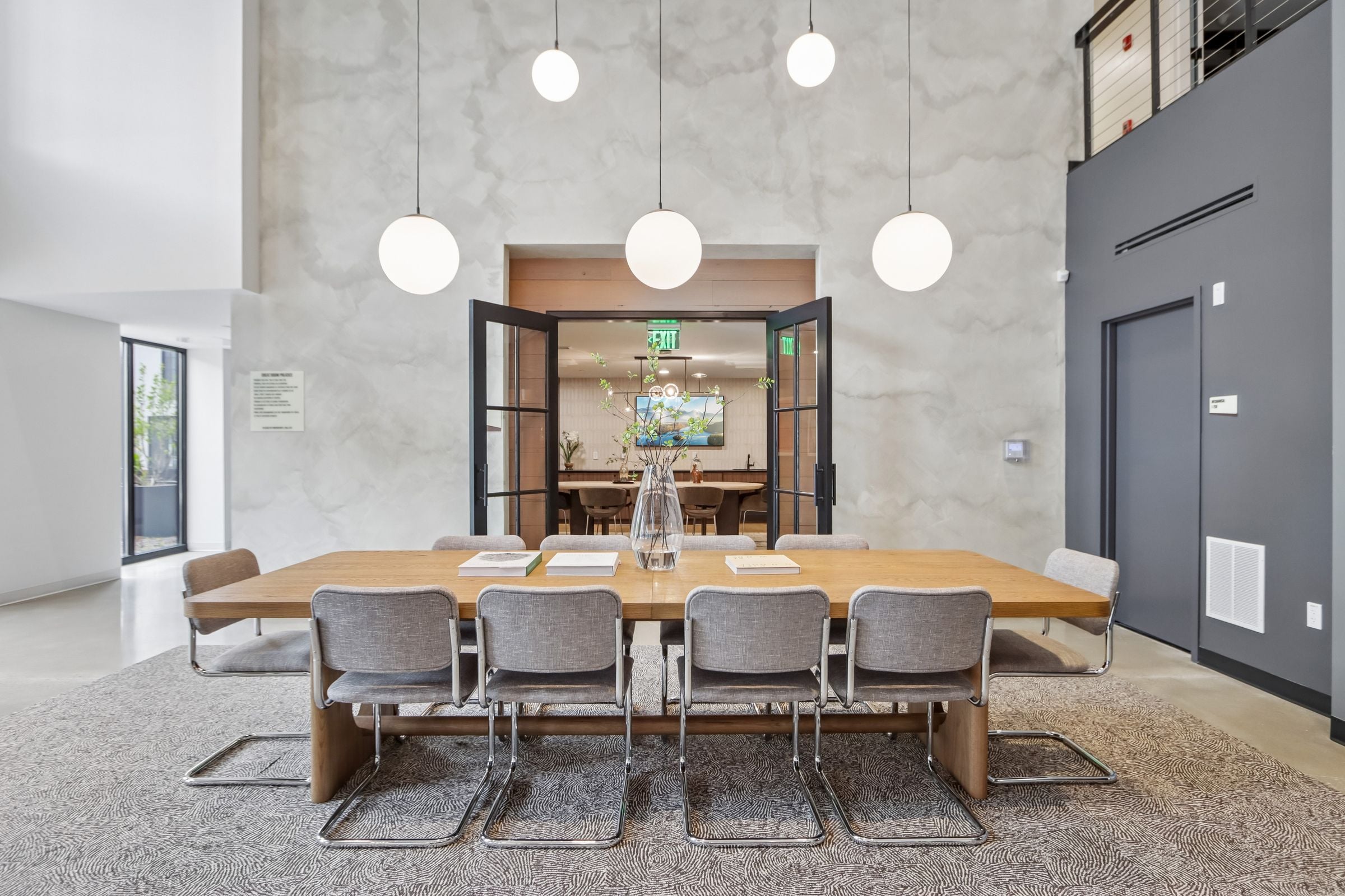 A conference room with a long table and chairs.