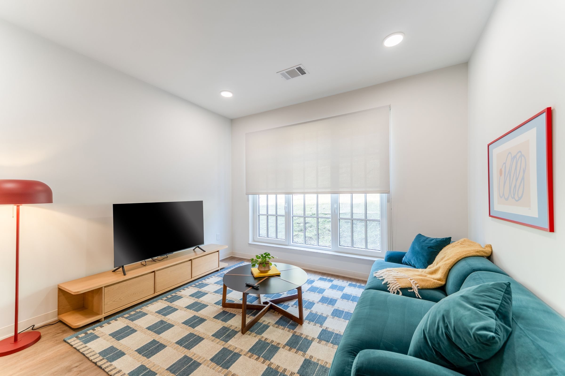 A living room with a blue couch and a television.