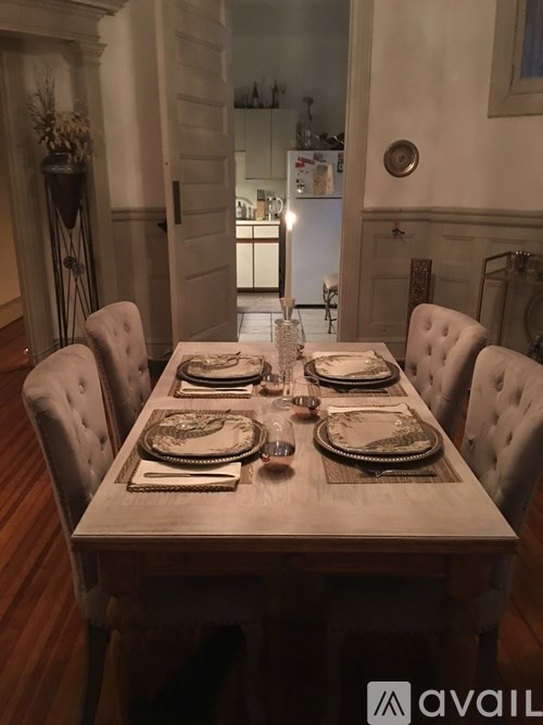A dining table set for a meal with plates and glasses on it.