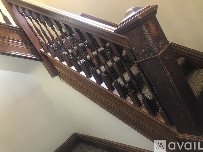 A wooden staircase with a carved balustrade.