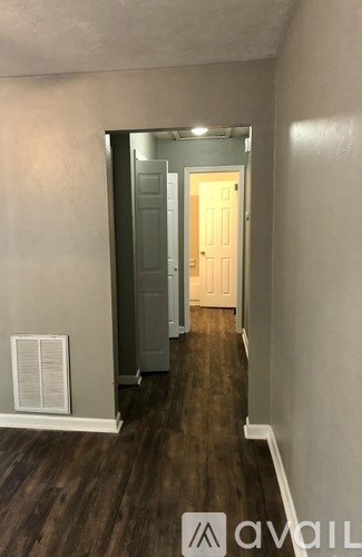 A hallway with a door at the end.