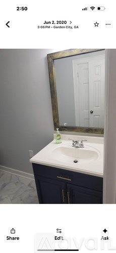 A bathroom with a white sink and a mirror above it.