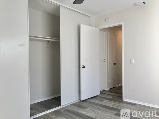 A white door is open to a hallway.